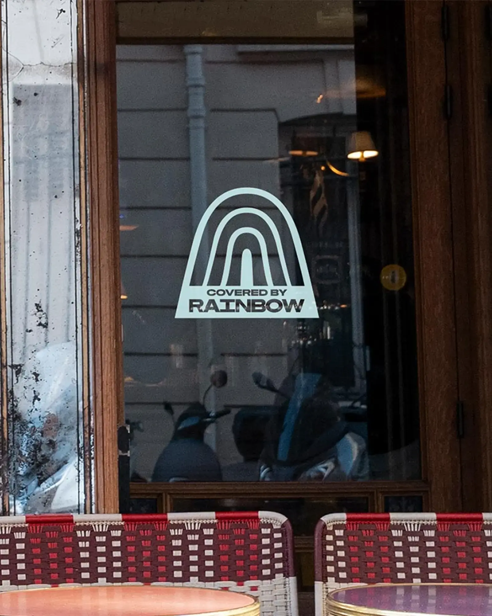 A Covered by Rainbow sticker on a restaurant window