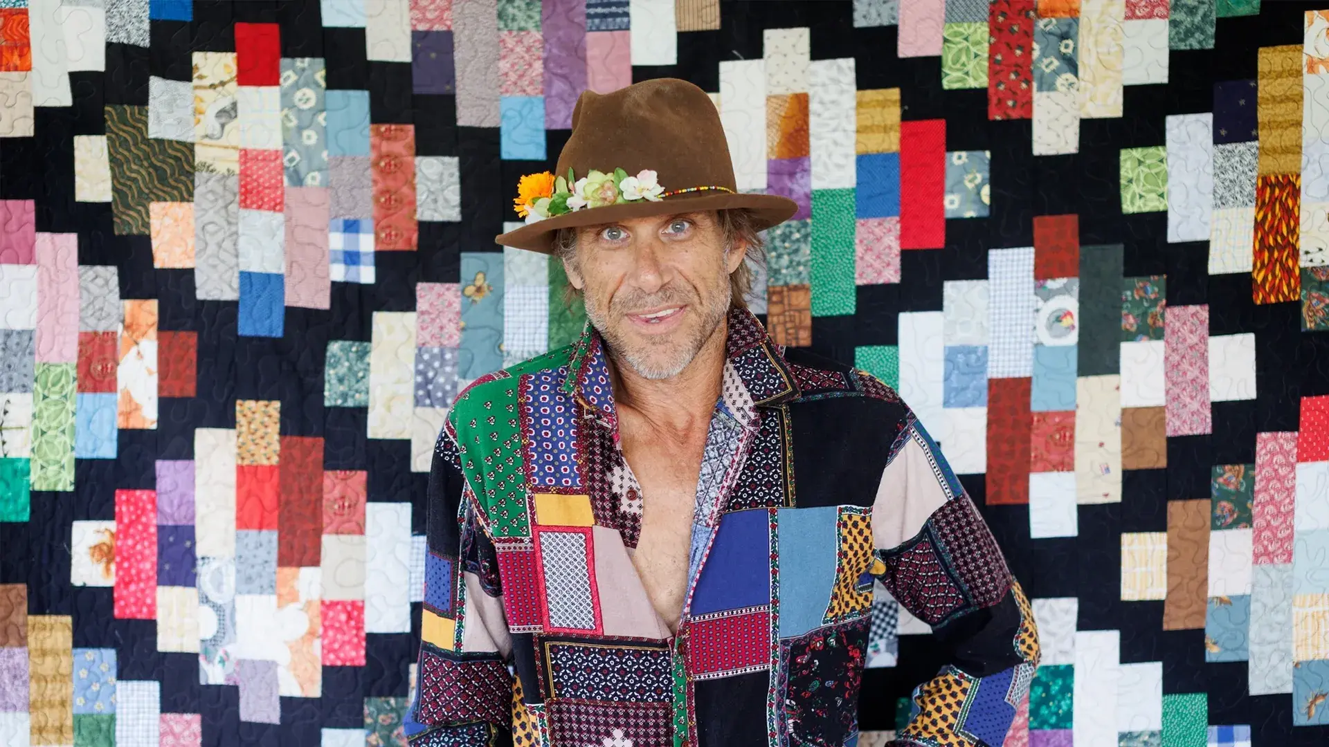 Todd Snider in front of a patchwork quilt